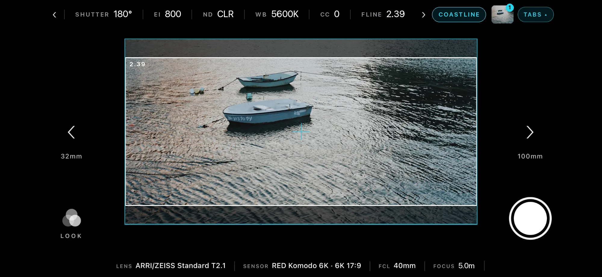 Viewfinder framing two rowing boats on rippled water at 2.39, with camera settings across the top and the lens and sensor below